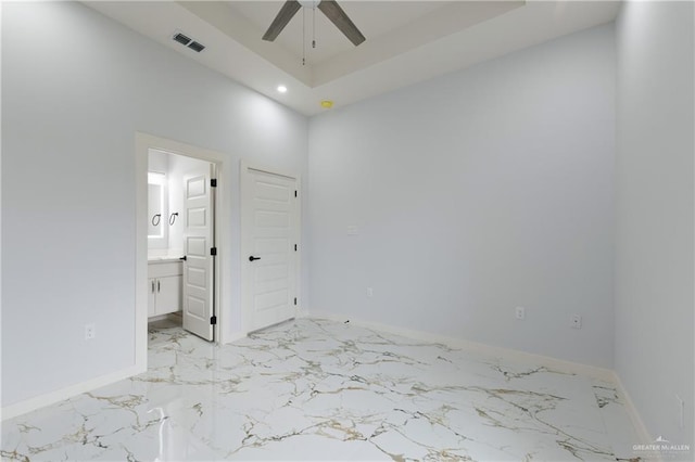 unfurnished bedroom featuring visible vents, baseboards, marble finish floor, and ensuite bathroom