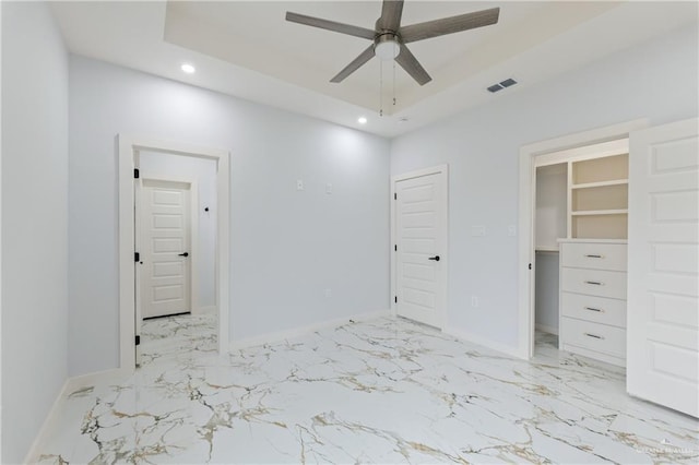 unfurnished bedroom featuring recessed lighting, visible vents, a raised ceiling, and baseboards