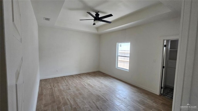 2721 Chesterfield Ave, Edinburg, TX 78539 - spare room with a raised ceiling, wood finished floors, a ceiling fan, and baseboards