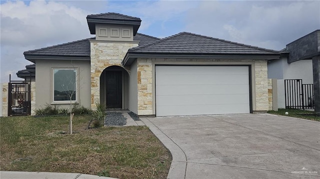 view of front of house featuring a garage and a front lawn