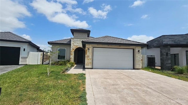 2721 Chesterfield Ave, Edinburg, TX 78539 - view of front facade featuring stone siding, driveway, a garage, and a tiled roof