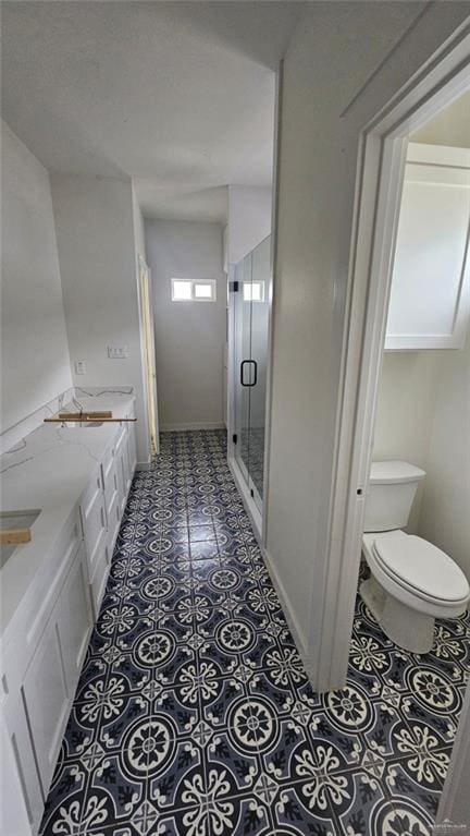 2721 Chesterfield Ave, Edinburg, TX 78539 - bathroom featuring toilet, a stall shower, and double vanity