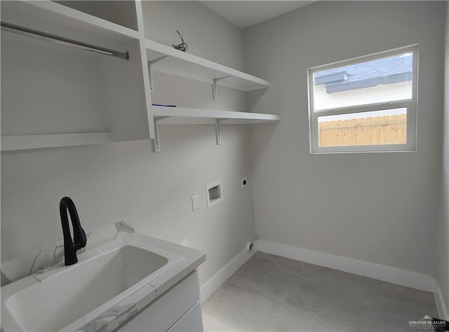 washroom with hookup for a washing machine, hookup for an electric dryer, a sink, laundry area, and baseboards