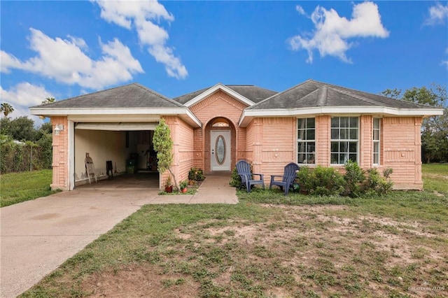 3019 Floresta St, Edinburg, TX 78541 - view of front of home featuring an attached garage, concrete driveway, and a front lawn