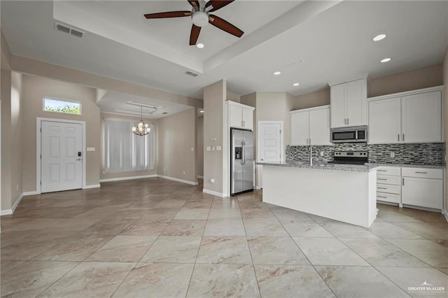 kitchen with visible vents, light stone counters, backsplash, appliances with stainless steel finishes, and ceiling fan with notable chandelier