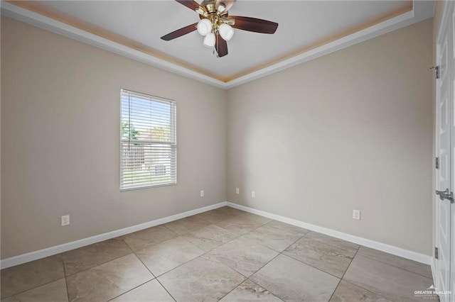 empty room featuring crown molding, a ceiling fan, and baseboards