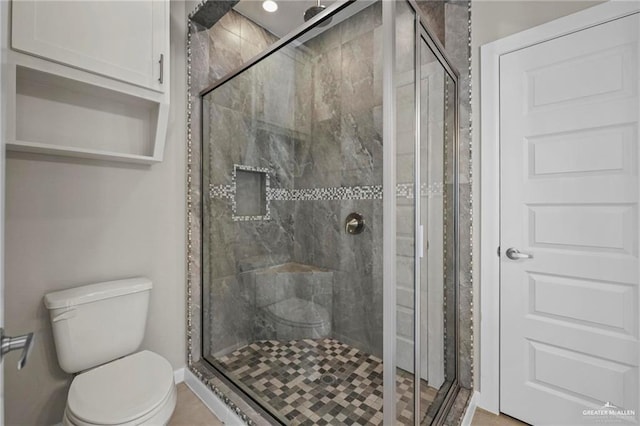 full bath featuring toilet and a stall shower