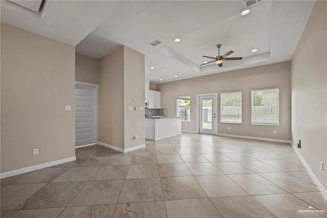 unfurnished living room featuring baseboards, visible vents, a ceiling fan, and recessed lighting