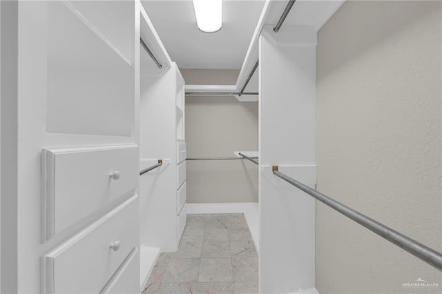 spacious closet with marble finish floor