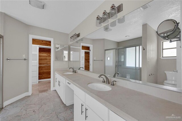 bathroom with a sink, baseboards, visible vents, and marble finish floor