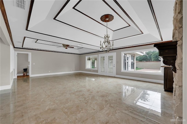 unfurnished living room with baseboards, marble finish floor, ceiling fan with notable chandelier, and a wealth of natural light