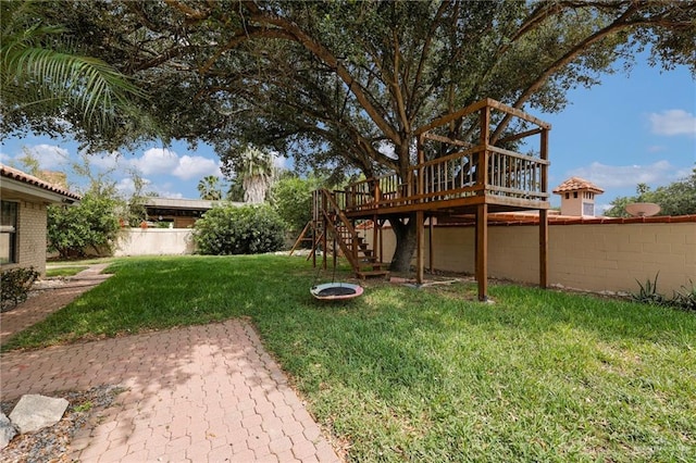 view of yard featuring fence, a patio, stairs, and a deck