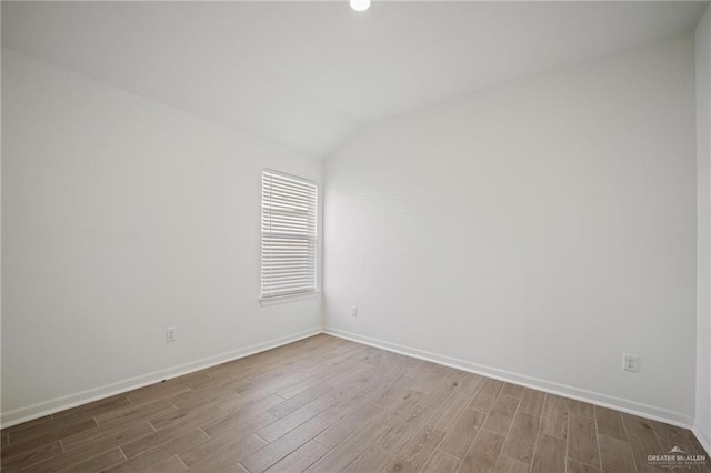 8306 N 34th Ln, Mcallen, TX 78504 - unfurnished room with wood finished floors, vaulted ceiling, and recessed lighting