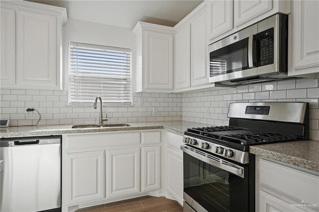 8306 N 34th Ln, Mcallen, TX 78504 - kitchen featuring appliances with stainless steel finishes, white cabinets, and decorative backsplash