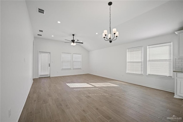 8306 N 34th Ln, Mcallen, TX 78504 - unfurnished living room featuring a ceiling fan, vaulted ceiling, a chandelier, wood finished floors, and recessed lighting