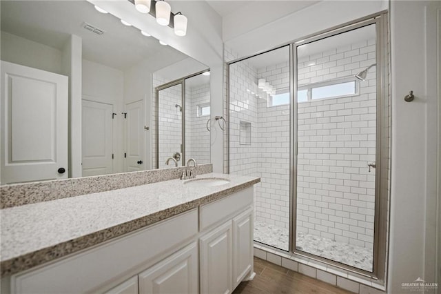 8306 N 34th Ln, Mcallen, TX 78504 - bathroom with a shower stall, vanity, and wood finished floors