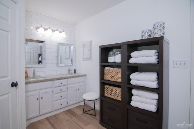 2915 N Franklin Rd, Edinburg, TX 78541 - full bathroom featuring double vanity, wood finished floors, and backsplash