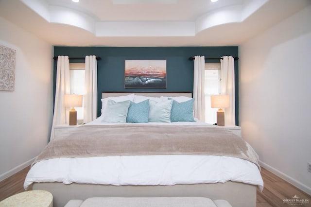 2915 N Franklin Rd, Edinburg, TX 78541 - bedroom featuring a raised ceiling, wood finished floors, and recessed lighting