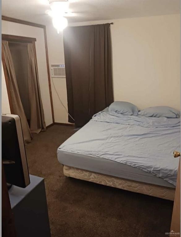 carpeted bedroom with a wall mounted air conditioner