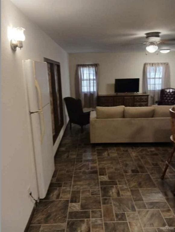 living room with a healthy amount of sunlight and ceiling fan