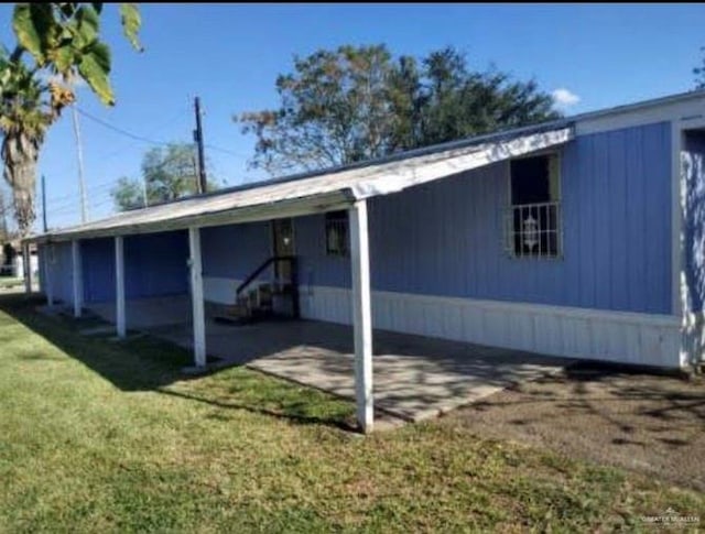 view of side of property with a yard