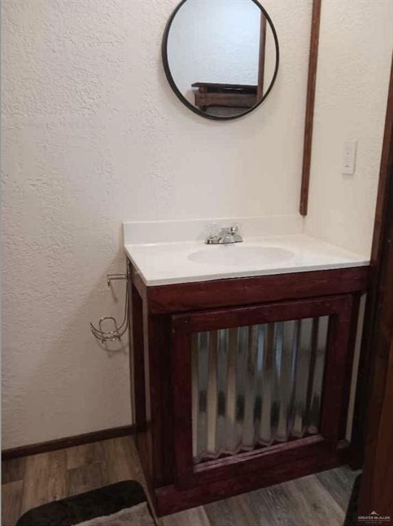 bathroom with vanity and hardwood / wood-style floors