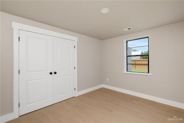 1817 Dolores Del Rio Ave, Mission, TX 78572 - unfurnished bedroom with baseboards, light wood-type flooring, and a closet