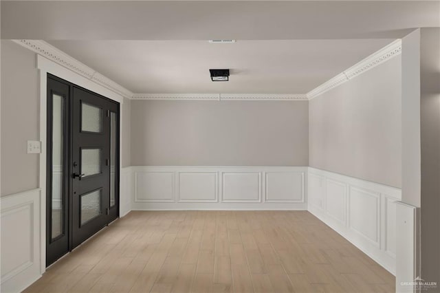 1817 Dolores Del Rio Ave, Mission, TX 78572 - entryway featuring light wood-style flooring, a wainscoted wall, a decorative wall, and ornamental molding