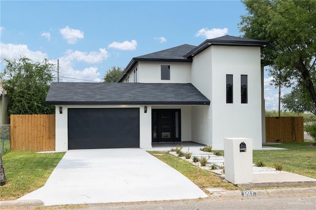1817 Dolores Del Rio Ave, Mission, TX 78572 - view of front of house featuring stucco siding, fence, an attached garage, and driveway