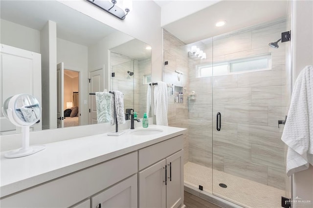 bathroom with walk in shower and vanity