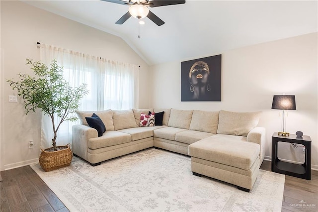 living room featuring wood-type flooring, lofted ceiling, and ceiling fan