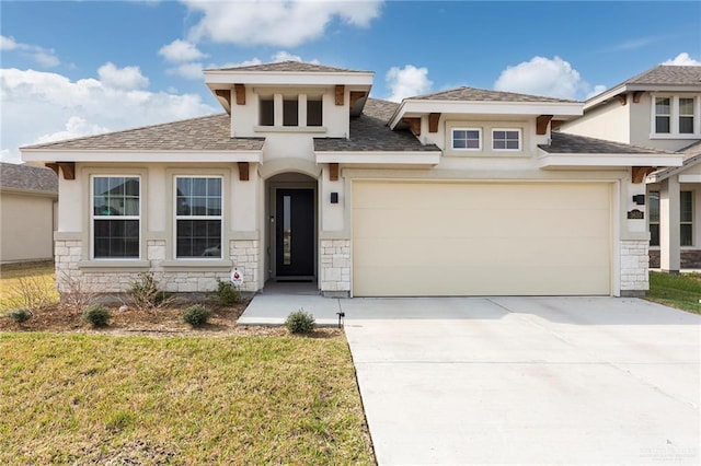 prairie-style home with a garage and a front yard