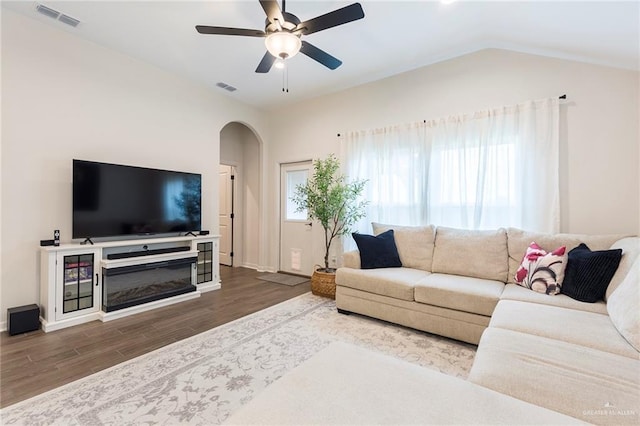 living room with hardwood / wood-style flooring, lofted ceiling, and ceiling fan