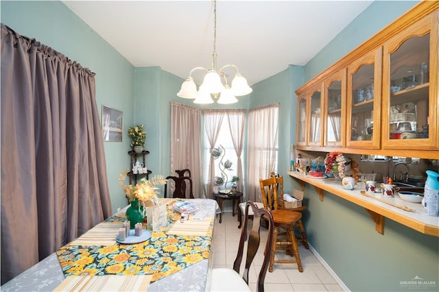 dining area with a notable chandelier, light tile patterned floors, and sink