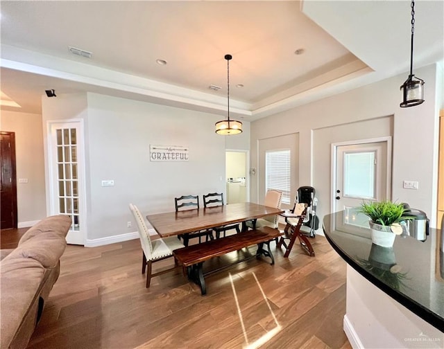 3530 Los Lagos Dr, Edinburg, TX 78542 - dining space with light wood-type flooring, visible vents, and a raised ceiling