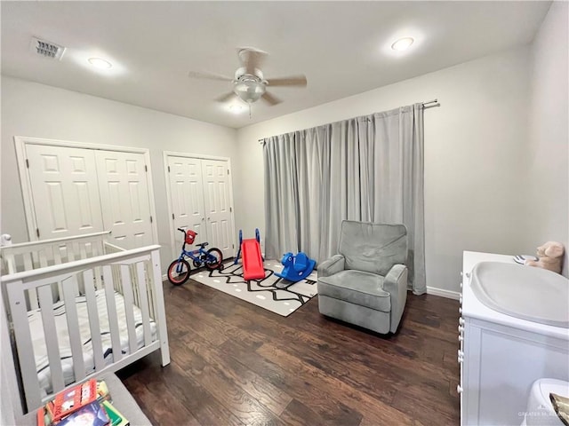 3530 Los Lagos Dr, Edinburg, TX 78542 - bedroom with dark wood finished floors, two closets, visible vents, and baseboards