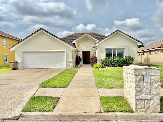 3530 Los Lagos Dr, Edinburg, TX 78542 - single story home with stucco siding, stone siding, concrete driveway, and a garage