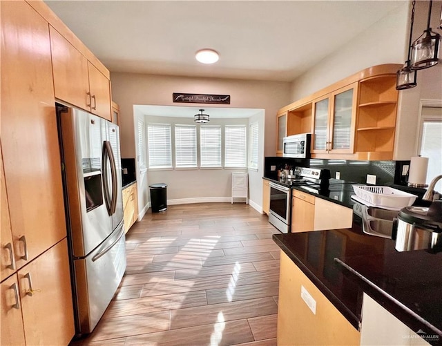 3530 Los Lagos Dr, Edinburg, TX 78542 - kitchen with dark countertops, open shelves, light brown cabinetry, pendant lighting, and stainless steel appliances