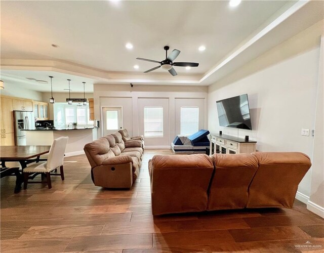 3530 Los Lagos Dr, Edinburg, TX 78542 - living area with baseboards, wood finished floors, a tray ceiling, and ceiling fan