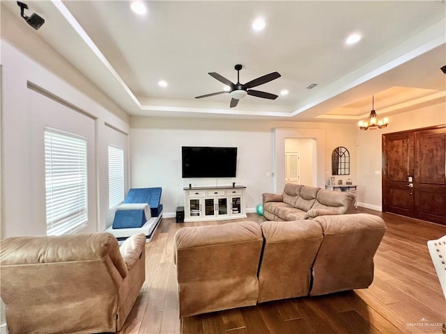 3530 Los Lagos Dr, Edinburg, TX 78542 - living room with dark wood-style flooring, ceiling fan with notable chandelier, visible vents, and a raised ceiling