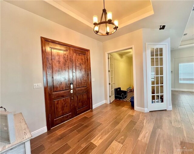 3530 Los Lagos Dr, Edinburg, TX 78542 - entrance foyer with baseboards, wood finished floors, an inviting chandelier, and a raised ceiling