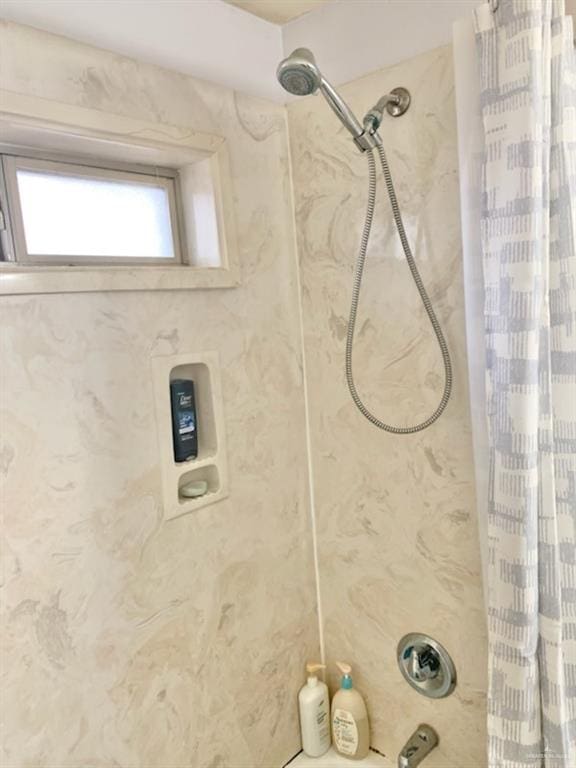 bathroom with shower / bathtub combination with curtain