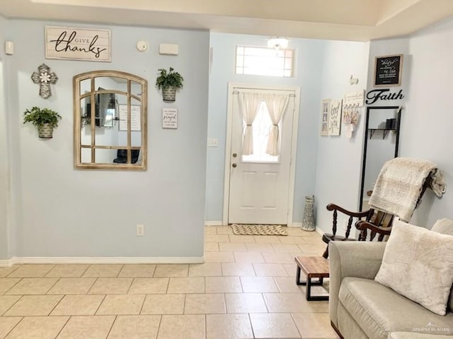 foyer featuring baseboards