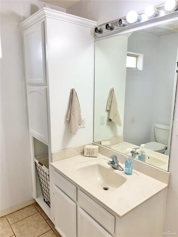 bathroom featuring vanity, tile patterned floors, and toilet