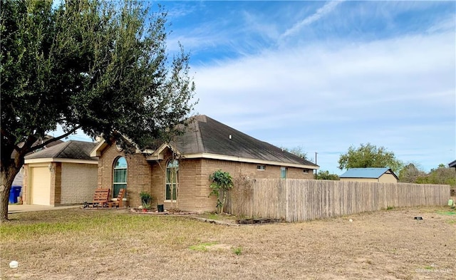 ranch-style home featuring a garage and a front yard