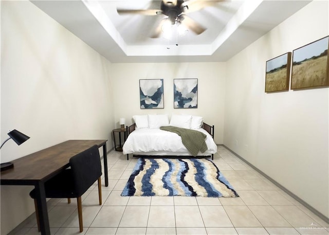 bedroom featuring light tile patterned floors, ceiling fan, and a raised ceiling