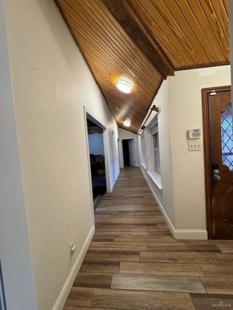 corridor with vaulted ceiling with beams, dark hardwood / wood-style flooring, and wood ceiling