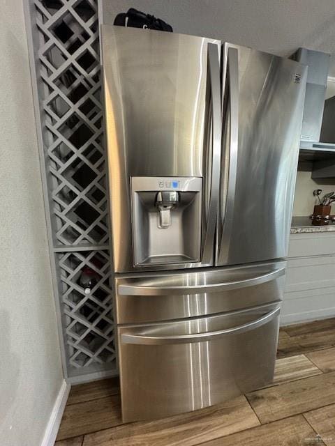 interior details with stainless steel fridge and stovetop