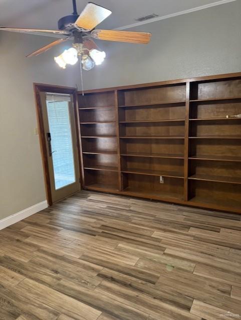 interior space with wood-type flooring and ceiling fan