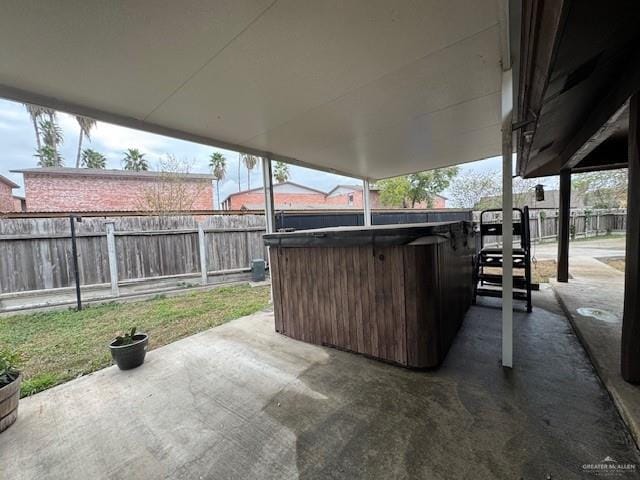 view of patio with a bar and a hot tub